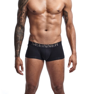 Close-up of premium cotton men's boxer briefs showing metallic logo waistband and fit