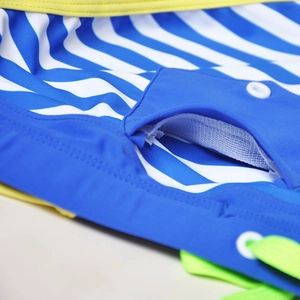 Detail of nautical striped swim briefs with white mesh lining pocket and yellow trim