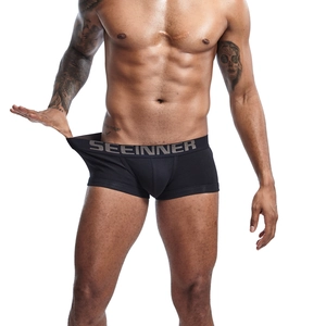 Close-up of men's black cotton boxer briefs with elastic waistband and brand logo