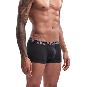 Detailed view of black cotton boxer briefs featuring U-pouch and logo waistband