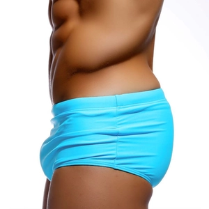 Detail view of bright blue men's swim trunks featuring elastic quick-dry fabric and fit
