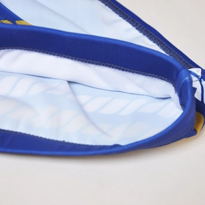 Detail of blue men's swim trunks featuring reinforced stitching and breathable mesh lining