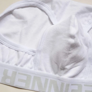 Detailed close-up of white cotton men's briefs with U-convex pouch and INNER waistband