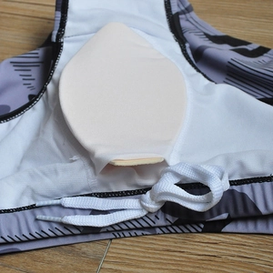 Detail of grey camo swim trunks showing the removable cup padding and drawstring waist