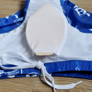 Detail of men's blue swim trunks showing internal white protective padding and drawstring