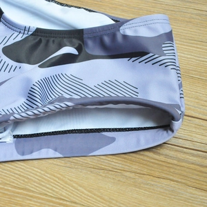 Detail of gray camouflage men's swim trunks with seamless stitching and white inner lining