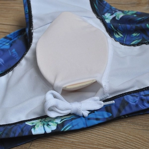 Detail of men's tropical leaf swim trunks showing white mesh lining and removable cup pads