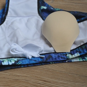 Detail view of men's floral swim trunks featuring mesh lining and removable padding inserts