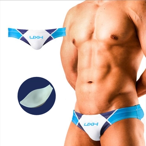 Detail view of men's color-block swim briefs with removable push-up sponge padding