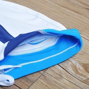 Detail of blue patchwork men's swim briefs showing stitching and white drawstring