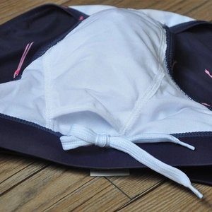 Detail of blue men swim trunks showing breathable white mesh lining and drawstring