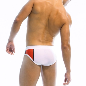 Rear view of men's white athletic swim briefs with orange and black geometric side patchwork