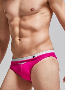 Detail of rose red men's swim briefs with white elastic waistband and button accent