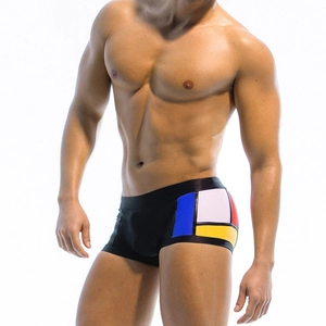 Men's geometric patchwork swim trunks with multicolor Mondrian blocks and elastic waistband