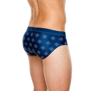 Men's geometric print swim briefs in navy blue, low-rise fit seen from a side-rear view