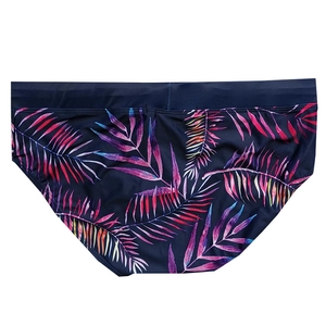 Men's swim trunks with vibrant tropical leaf prints and elastic waistband in navy blue