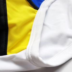 Close-up of color-block swim trunks with precise double-stitch sewing and high-elastic fabric