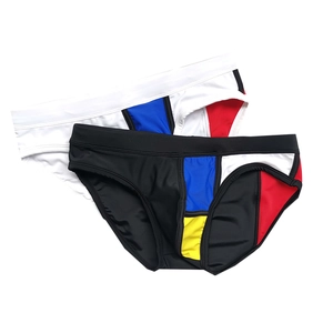 Detailed flat lay of men's swim briefs featuring colorful geometric patchwork design