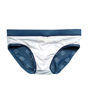 Detail of men's swim briefs showing breathable honeycomb fabric and geometric arrow prints