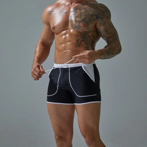 Detail of men's quick-dry swimming trunks with side pockets and stylish white contrast trim