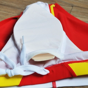 Detailed close-up of men's swim trunks with padding pocket and yellow waistband
