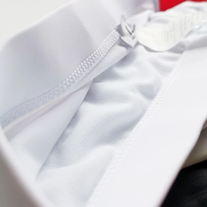 Detailed macro shot of white men's swim trunks with drawstring and reinforced stitching