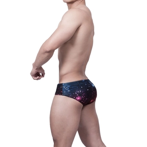 Detail of men's low-waist swim briefs featuring a colorful pixelated digital print design