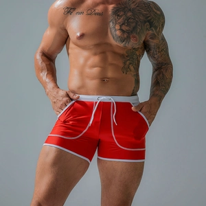 Close-up of quick-dry red swim trunks with white drawstrings and side pocket detail