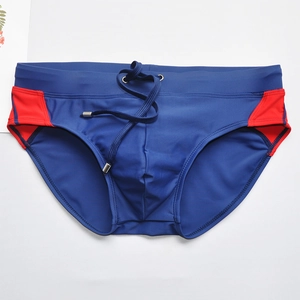 Detail of navy swim briefs with red side panels, elastic waist and metal tipped drawstrings