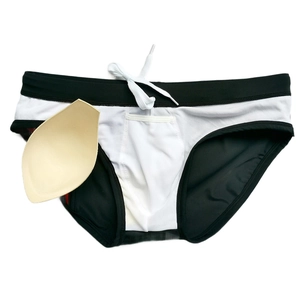 Men's swimwear detail showing contrast stitching, drawstring, and padded insert cup