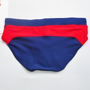 Detailed flat lay of men's quick-dry swim briefs in navy blue and red color block design