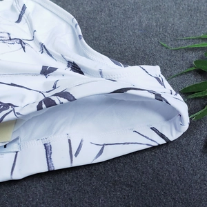 Detail view of swim trunks featuring ink wash bamboo print and reinforced stitching