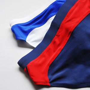 Detail of contrast color swimwear with flat-lock seams and elastic quick-dry fabric