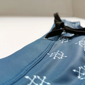 Detailed macro shot of navy blue swim briefs showing waist stitching and white arrow logo