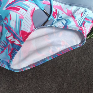 Detailed view of men's tropical print swim shorts featuring drawstring with metal tips