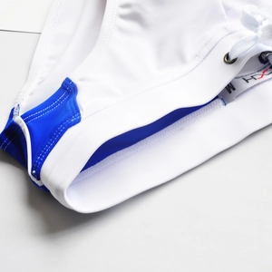 Detail of men's swim briefs featuring blue contrast panels and drawstring waist with size M