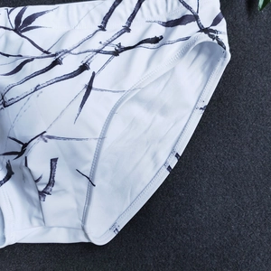 Macro detail of men's swim briefs with Chinese style black bamboo ink printing and soft lining