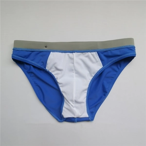 Detail of men's athletic swim briefs showing blue, white and grey patchwork and waistband