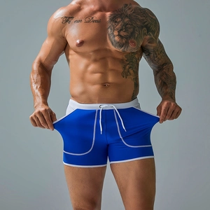 Detail of royal blue men's swim trunks with white drawstring and side stitching