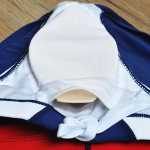 Detail of men's swim briefs featuring interior padded cup pouch and white drawstring