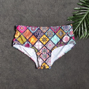 Detail of high-waisted swim shorts featuring colorful bohemian mandala geometric prints