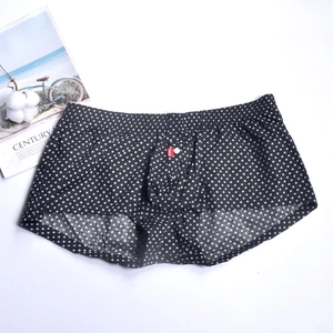Detail view of men's cotton boxer shorts with white cross pattern and red brand label