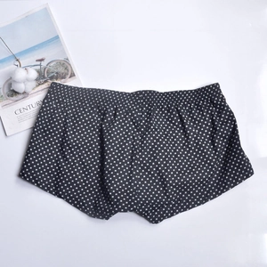 Flat lay of men's cotton boxer shorts with white cross patterns and elastic waistband