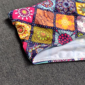 Detail of vibrant mandala print men's swim trunks with premium flatlock stitching