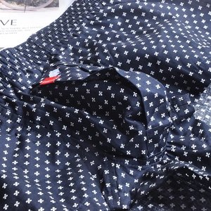 Close-up of navy cotton boxers with white floral print, elastic waist and button detail
