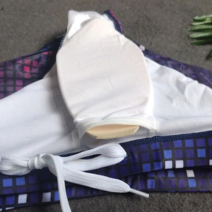 Detail of men's swim trunks featuring a mesh lining, removable pad, and drawstring