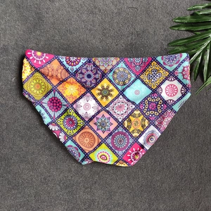 Close-up of men's swim briefs featuring colorful bohemian mandala patterns and quick-dry fabric