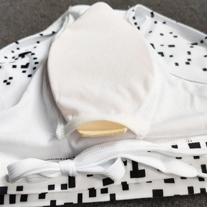 Detail view of swim top showing removable padding cup and pixel pattern print