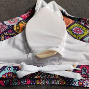 Detail view of ethnic mandala print swim trunks with mesh lining and white padded cup support