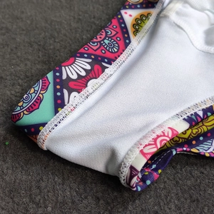 Detail view of colorful mandala print swim briefs with soft white elastic lining
